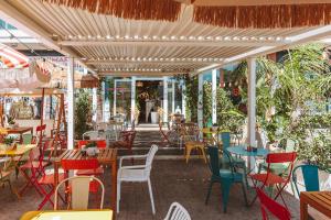 a restaurant with colorful chairs and tables and chairs at Maison 31 - Unique Experience in Civitavecchia