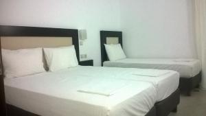 Postel nebo postele na pokoji v ubytování Hotel Dellis