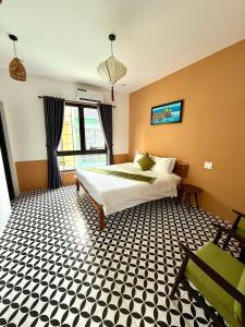 a bedroom with a bed and a large window at An Bang Chic Villa Nguyên Căn in Tân Thành (1)