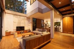 a living room with a couch and a tv at Villa Pakuk by Alfred in Bali in Canggu