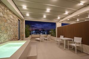 a room with a pool and a table and chairs at Sophe Boutique Stay 2 in Kallithea Halkidikis