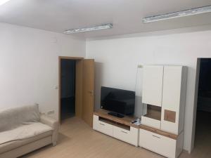 a living room with a television and a couch at Amor in Klake