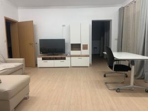 a living room with a tv and a couch and a table at Amor in Klake