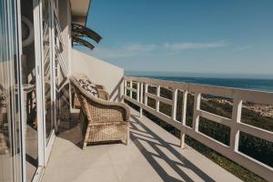a balcony with a view of the ocean at La Melamire On the Rocks Bed & Breakfast in Gansbaai