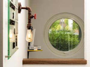a light fixture in a room with a mirror at ibis Styles Hotel Gelsenkirchen in Gelsenkirchen