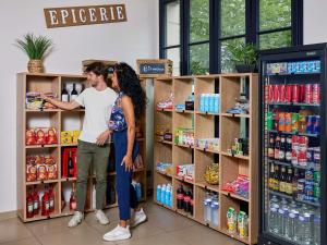 a man and a woman standing in a store shelf at Adagio Serris Val d'Europe in Serris
