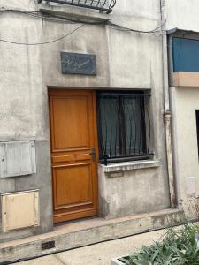 a building with a wooden door and a window at Les Marais 2 in Le Pré-Saint-Gervais