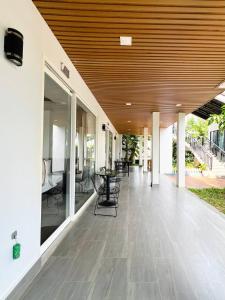 an empty patio with tables and chairs in a building at Sandy Residence Sihanoukville in Sihanoukville