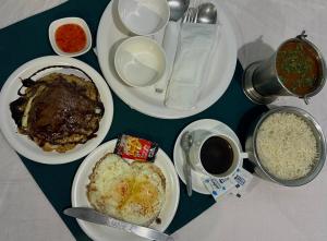 a table with plates of food and a cup of coffee at Hill Ice Guesthouse & Cafe - Mountain View & Balcony, Tosh in Tosh
