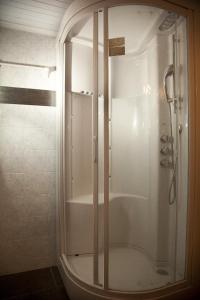 a shower with a glass door in a bathroom at Filoxenia Hotel Monemvasia in Monemvasia