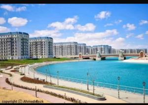 a large body of water with buildings and a bridge at New Alamein Latine district Spacious studio direct Lagon view in El Alamein