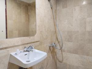 a bathroom with a sink and a shower at SNUZ Hotel Menteng in Jakarta +68 photos