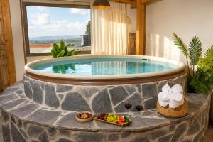 a swimming pool with a table of food and fruit at סוויטת דרים רויאל - סוויטה חלומית עם אמבט ספא מפנק ונוף מדהים in ‘Ein Ya‘aqov