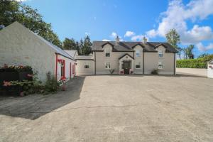 a large house with a driveway in front of it at Greenfield House in Aghavas