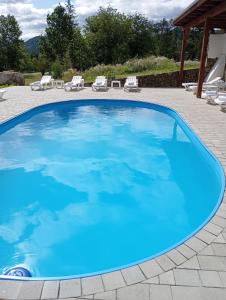 a large blue swimming pool on a patio at Шешори Еко in Sheshory