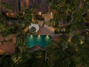 an overhead view of a pool at a resort at night at The Campuhan Retreat in Munggu