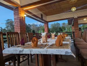 a table on a patio with chairs and a tableablish at Dual Mountain View Lodge in Moshi