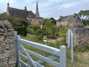 a glass of wine sitting on a white fence at Canutes Field bell tent in Nassington
