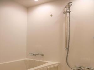 a bathroom with a bath tub and a shower at ibis Styles Tokyo Bay in Urayasu +36 photos