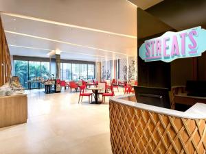 a restaurant with red chairs and tables and a sign that reads steals at ibis Styles Bangkok Sukhumvit 4 in Bangkok +52 photos