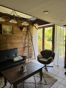 a living room with a couch and a chair at Rimbes Casteljaloux - Gite 6 pers in Casteljaloux