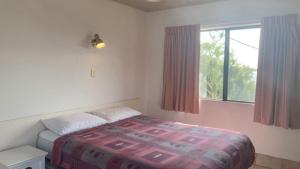 a bedroom with a bed and a window at Brighton Le Sands Unit 6 in Golden Beach +3 photos