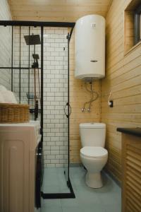 a bathroom with a white toilet and a sink at Haiku Cottages in Merisi +33 photos