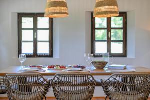 a dining room table with chairs and two windows at Country home Lagom in Zagorska Sela +34 photos