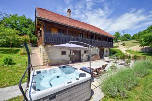 a house with a hot tub in front of it at Country home Lagom in Zagorska Sela