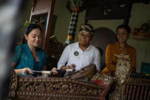 a group of three people sitting next to a table at Villa Canggu by Plataran in Canggu +137 photos