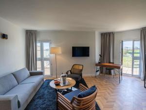 a living room with a couch and a table at Mercure Chantilly Resort & Conventions in Chantilly