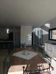 a dining room with a wooden table and chairs at Au domaine Isabelle in Lorgues