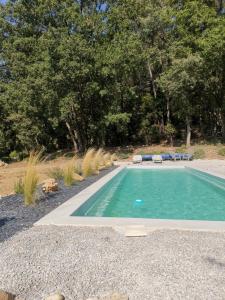 a swimming pool with two lounge chairs in a yard at Au domaine Isabelle in Lorgues
