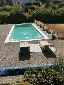 a swimming pool with two lounge chairs in a yard at Au domaine Isabelle in Lorgues
