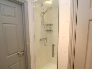 a bathroom with a shower with a glass door at Ocean Gem in Carbis Bay +29 photos