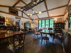 a dining room with tables and chairs in a house at Goseong Maris Pension in Goseong +4 photos