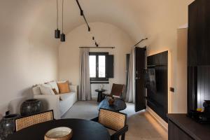 a living room with a couch and a table at Avento Luxury Suites in Santorini