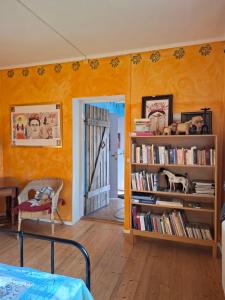 a room with a book shelf with books at Frida in Filipstad