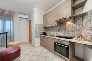 a kitchen with wooden cabinets and a counter top at Stella Del Sud in Squinzano +28 photos