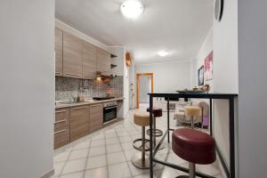 a kitchen with a counter and stools in it at Stella Del Sud in Squinzano