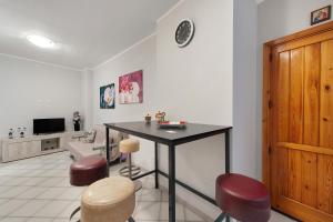 a room with a table and stools and a tv at Stella Del Sud in Squinzano