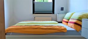 a bedroom with two beds and a window at Waldblick Nordhorn in Nordhorn +2 photos