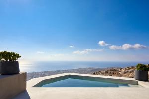 a swimming pool on top of a house at Santorini Sky, The Lodge in Pyrgos