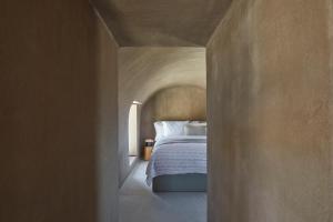 a bedroom with a bed in a hallway at Santorini Sky, The Lodge in Pyrgos +13 photos