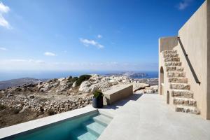 a house on a hill with a swimming pool at Santorini Sky, The Lodge in Pyrgos