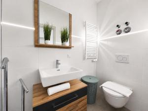 a white bathroom with a sink and a toilet at Bergzauber am Semmering in Semmering +38 photos