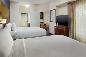 a hotel room with two beds and a television at Residence Inn by Marriott Augusta in Augusta +36 photos