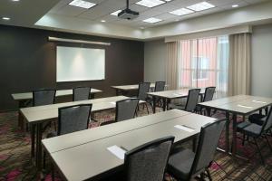 a conference room with tables and chairs and a screen at Residence Inn by Marriott Augusta in Augusta