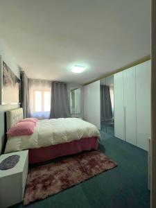 a bedroom with a large bed and a rug at La Cascata in Valbrenta 