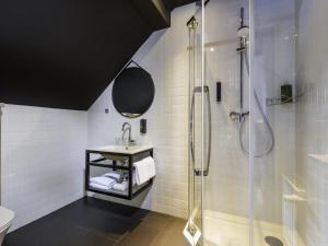 a bathroom with a shower and a sink at ibis Styles Dresden Neustadt in Dresden +52 photos